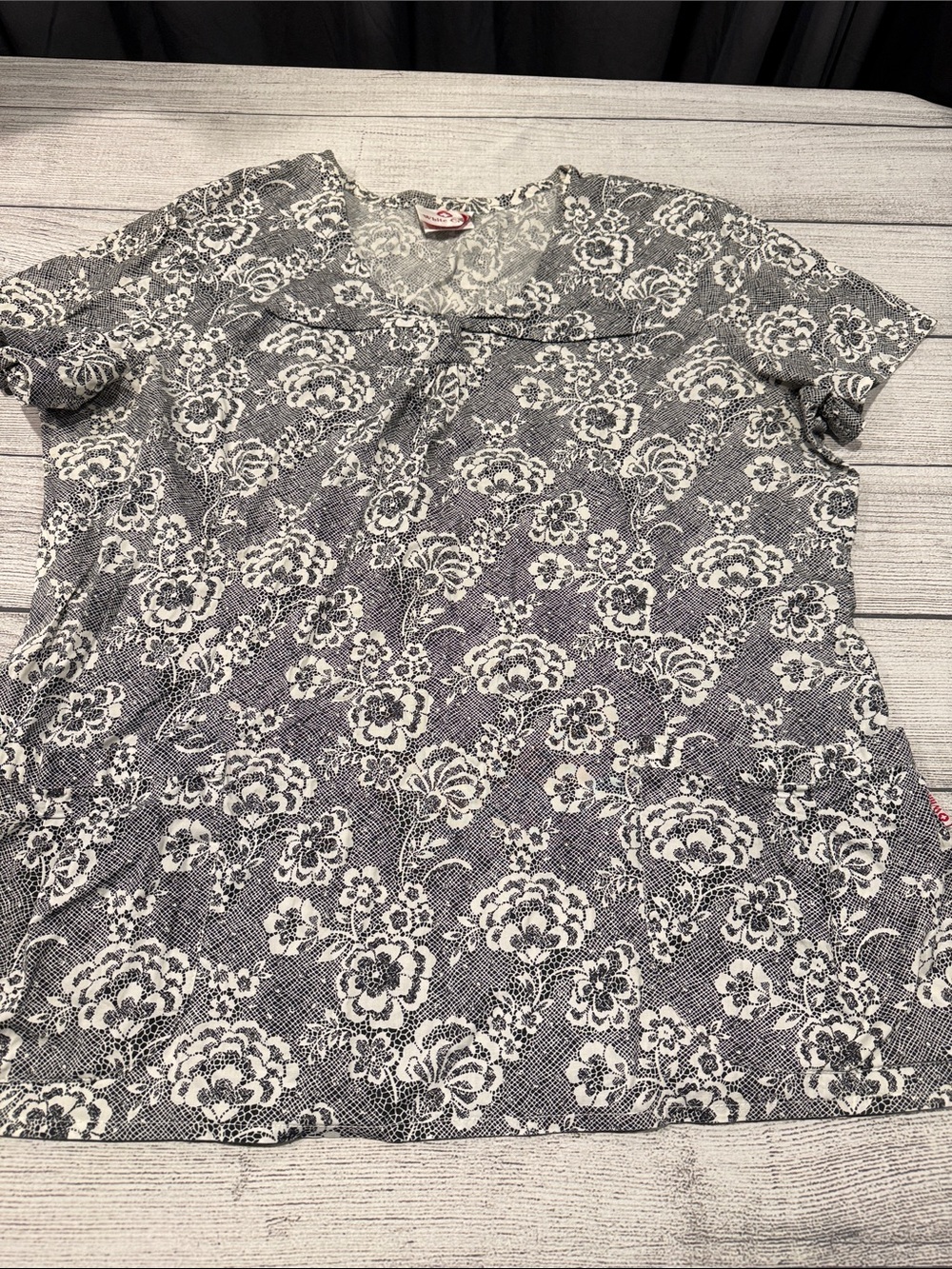 White Cross nurses scrub top black/white floral print unsized PTP approx 23”